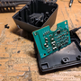 hardware_adding_a_power_jack_to_a_battery_powered_dremel_charger_base_base_disassembled.png